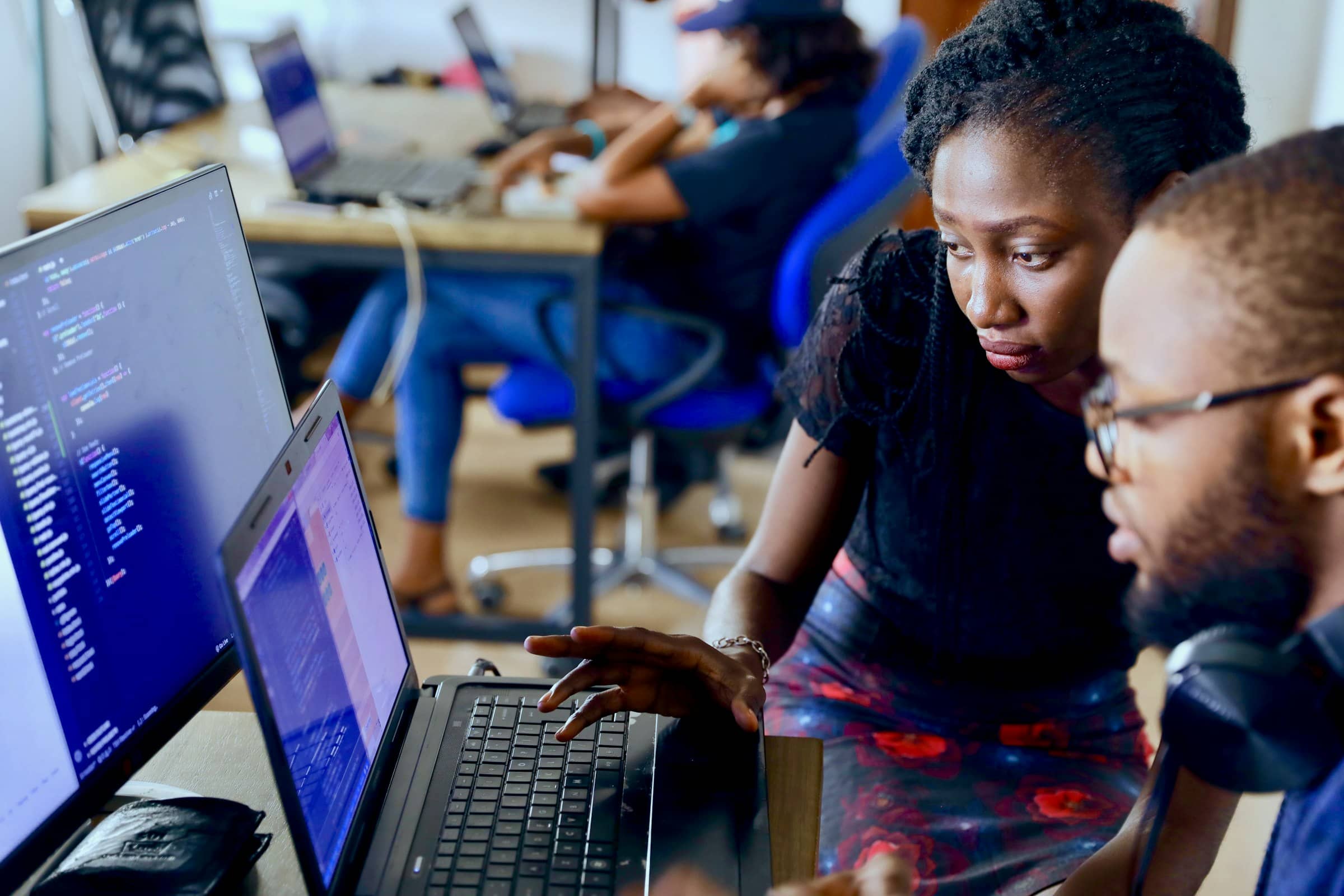 Analysts working with data on laptops